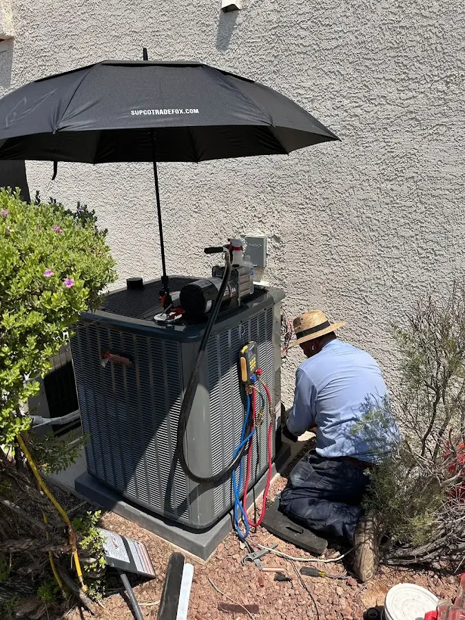 HVAC technician performing outdoor AC maintenance in Donaldsonville